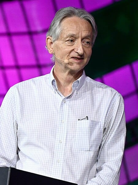 Photograph of Geoffrey Hinton speaking at a conference