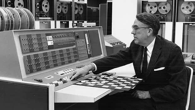 Photo of IBM AI pioneer Arthur Samuel with his checkers playing computer